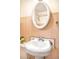 Bathroom featuring a pedestal sink, vintage mirror, and pink tiling at 3719 W 30Th Ave, Denver, CO 80211