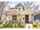 Charming front exterior with white brick, decorative ironwork, and inviting porch seating at 3719 W 30Th Ave, Denver, CO 80211