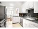 Bright kitchen featuring classic white cabinetry, stainless steel appliances, and sleek countertops at 3719 W 30Th Ave, Denver, CO 80211