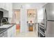 Bright kitchen features white cabinetry, stainless steel appliances, and pantry at 3719 W 30Th Ave, Denver, CO 80211