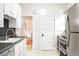Bright kitchen features white cabinetry, stainless steel appliances, and contrasting countertops at 3719 W 30Th Ave, Denver, CO 80211