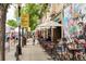 Outdoor dining at the Highlands, with decorative murals and people enjoying the vibrant atmosphere at 3719 W 30Th Ave, Denver, CO 80211