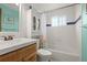 Bathroom featuring a white vanity, toilet, tub/shower combination, and built-in cabinet for storage at 10805 Verna Ln, Northglenn, CO 80234