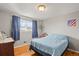 Bedroom with hardwood floors, window and blue curtains at 10805 Verna Ln, Northglenn, CO 80234