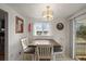 Bright dining room featuring a large window, stylish chandelier, and access to the outdoor patio at 10805 Verna Ln, Northglenn, CO 80234