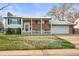 Charming two-story brick home with a covered front porch and a well-manicured lawn at 10805 Verna Ln, Northglenn, CO 80234