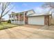 A well-maintained home with a brick facade, white trim, and an attached two-car garage at 10805 Verna Ln, Northglenn, CO 80234