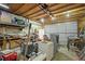 A cluttered garage interior showcasing storage and workspace potential at 10805 Verna Ln, Northglenn, CO 80234