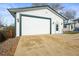 A detached garage with a wide door and classic exterior lighting at 10805 Verna Ln, Northglenn, CO 80234