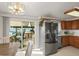 Bright kitchen with stainless steel appliances, wood cabinets, and sliding doors to the backyard at 10805 Verna Ln, Northglenn, CO 80234