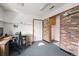 Home office setup featuring brick accents, carpet, and functional workspace at 10805 Verna Ln, Northglenn, CO 80234