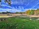 This large backyard has vibrant trees, a red house, and an outdoor space at 371 S Estes St # 10, Lakewood, CO 80226