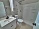 Bathroom featuring white vanity, toilet, and shower with a shower curtain and cabinet above at 371 S Estes St # 10, Lakewood, CO 80226