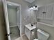 Bathroom features vanity, toilet, and mirror as well as an open doorway to a carpeted room at 371 S Estes St # 10, Lakewood, CO 80226