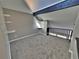 Bedroom featuring carpeted floors and sloped ceiling with a window and access to the staircase at 371 S Estes St # 10, Lakewood, CO 80226