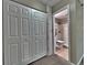 Hallway with a closet and doorway leading to bathroom featuring carpet flooring and painted walls at 371 S Estes St # 10, Lakewood, CO 80226