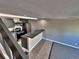 View of kitchen featuring black appliances and a breakfast bar with tile floors as seen from the staircase at 371 S Estes St # 10, Lakewood, CO 80226