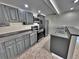 Modern kitchen with gray cabinets, stainless steel appliances, and tile flooring at 371 S Estes St # 10, Lakewood, CO 80226