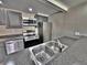 Modern kitchen with stainless steel appliances and tile flooring at 371 S Estes St # 10, Lakewood, CO 80226