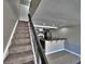 View of kitchen featuring black appliances and a breakfast bar with tile floors as seen from the staircase at 371 S Estes St # 10, Lakewood, CO 80226