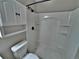 Bathroom featuring white cabinet above toilet and a white shower and showerhead with a black fixture at 371 S Estes St # 10, Lakewood, CO 80226