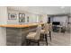 Finished basement bar area with wood countertop, rustic wood paneling, and seating at 7877 E 139Th Pl, Brighton, CO 80602