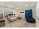 Finished basement with tile flooring offers a cozy sitting area and separate game area for entertainment at 7877 E 139Th Pl, Brighton, CO 80602