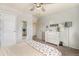 Neutral bedroom offers a dresser, ceiling fan, and doorway to a hallway, providing space and light at 7877 E 139Th Pl, Brighton, CO 80602
