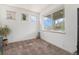 Bright bedroom with natural light, neutral carpet, and a view of the outside neighborhood at 7877 E 139Th Pl, Brighton, CO 80602