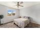 Bright bedroom filled with natural light showcases a ceiling fan and large window with neighborhood views at 7877 E 139Th Pl, Brighton, CO 80602