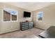 Bright bedroom provides plenty of space, natural light through two windows, and carpeted floors at 7877 E 139Th Pl, Brighton, CO 80602