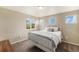 Cozy bedroom showcases a white metal bed frame and three windows offering picturesque views at 7877 E 139Th Pl, Brighton, CO 80602