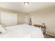 Comfortable bedroom displays a large bed, sliding closet doors, and a view into the hallway at 7877 E 139Th Pl, Brighton, CO 80602