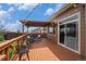 Outdoor deck with pergola, seating, and sliding glass door access at 7877 E 139Th Pl, Brighton, CO 80602