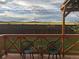 Tranquil deck view overlooking a fenced backyard and picturesque landscape at 7877 E 139Th Pl, Brighton, CO 80602