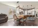 Dining area with wooden table set, view of the kitchen, and hardwood floors with natural light at 7877 E 139Th Pl, Brighton, CO 80602