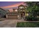 Charming two-story home featuring a large garage and stone facade at 7877 E 139Th Pl, Brighton, CO 80602