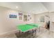 Spacious game room with ping pong table and wood-look flooring at 7877 E 139Th Pl, Brighton, CO 80602