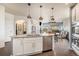 Modern kitchen featuring an island with granite countertops, stainless steel appliances, and pendant lighting at 7877 E 139Th Pl, Brighton, CO 80602