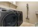 Modern laundry room featuring front load washer and dryer and tile floor at 7877 E 139Th Pl, Brighton, CO 80602