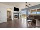 Inviting living room with a fireplace, large windows, hardwood floors, and comfortable seating at 7877 E 139Th Pl, Brighton, CO 80602