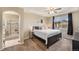 Bedroom with tray ceiling, ensuite bath with glass enclosed shower, and a neutral color palette at 7877 E 139Th Pl, Brighton, CO 80602