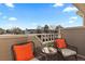 Cozy balcony featuring stylish seating with orange cushions and neighborhood views at 1818 S Quebec Way # 2-3, Denver, CO 80231