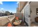 Comfortable balcony space with chairs, table, and a pleasant view, perfect for relaxation at 1818 S Quebec Way # 2-3, Denver, CO 80231