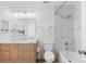 Bright bathroom featuring a wood vanity, marble shower, and updated fixtures at 1818 S Quebec Way # 2-3, Denver, CO 80231