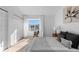 Bedroom featuring neutral decor, a large window, and light hardwood flooring at 1818 S Quebec Way # 2-3, Denver, CO 80231