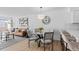 Bright dining area featuring a glass table, stylish chairs, and contemporary lighting, connecting seamlessly to the living area at 1818 S Quebec Way # 2-3, Denver, CO 80231