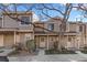 Townhome featuring a covered front porch and landscaped front yard at 1818 S Quebec Way # 2-3, Denver, CO 80231
