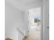 Hallway view leading to a bedroom with a bright window and light wood floors at 1818 S Quebec Way # 2-3, Denver, CO 80231