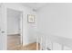 Bright hallway featuring light wood floors, white walls, and access to other rooms at 1818 S Quebec Way # 2-3, Denver, CO 80231
